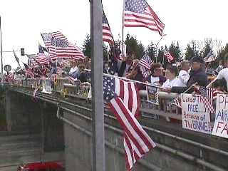 more people and flags on the overpass